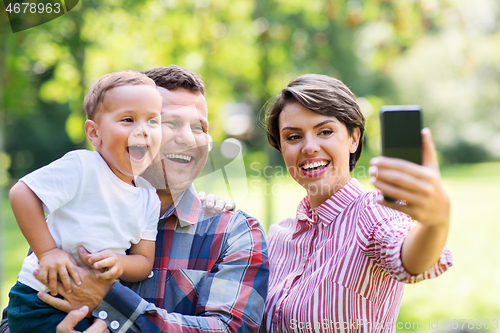 Image of happy family taking selfie at summer park