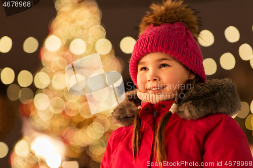 Image of happy little girl at christmas market in winter