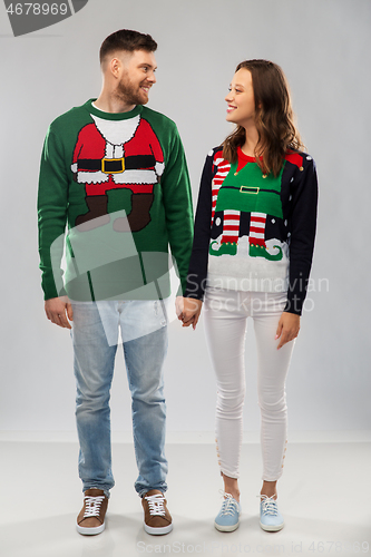 Image of happy couple at christmas ugly sweater party