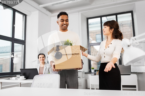 Image of new male employee with colleagues at office