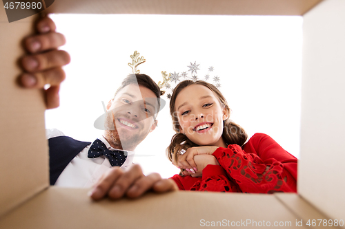 Image of happy couple opening christmas gift box