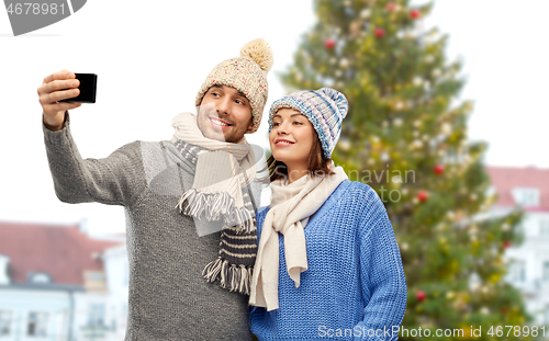 Image of couple taking selfie at christmas tree in tallinn