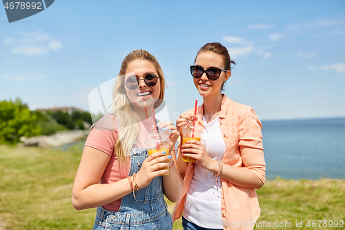 Image of teenage girls or friends with drinks in summer