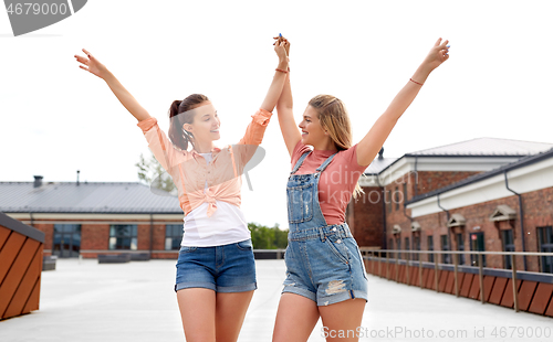 Image of teenage girls or friends on city street in summer