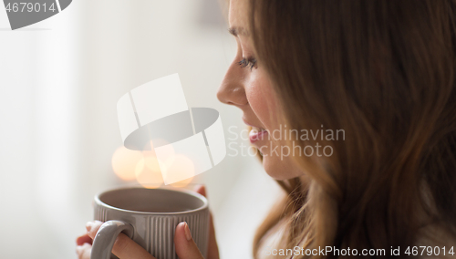 Image of close up of happy woman with cup of coffee at home