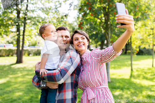 Image of happy family taking selfie at summer park