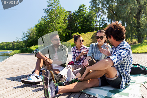 Image of friends hanging out and talking outdoors in summer