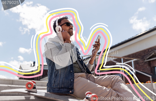 Image of man with smartphone and headphones on roof top