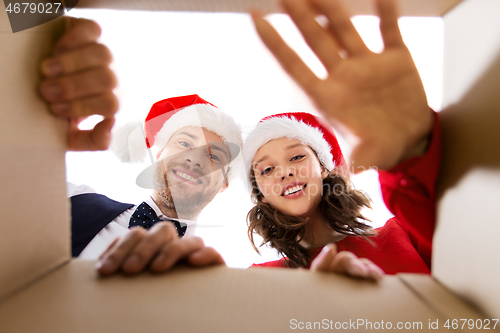 Image of happy couple opening christmas gift box