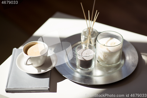 Image of coffee, candles and aroma reed diffuser on table