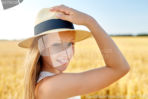 Image of portrait of girl in straw hat on field in summer