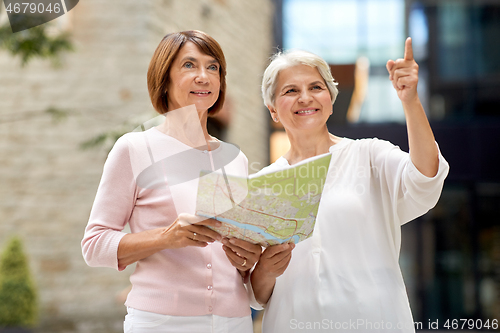 Image of senior women with city map on street in tallinn