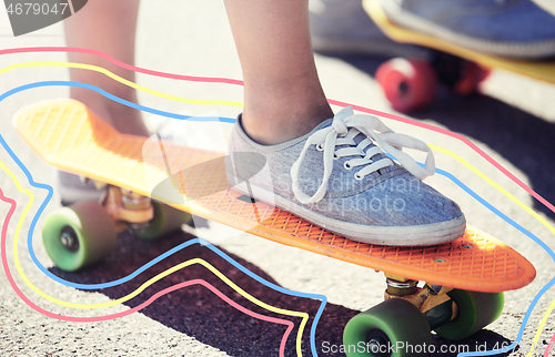 Image of close up of female feet riding short skateboard