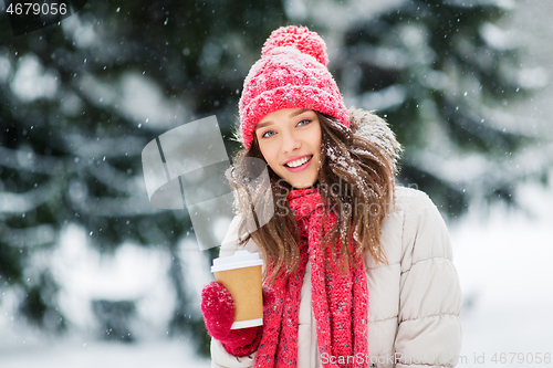 Image of happy teenage girl with coffee in winter park
