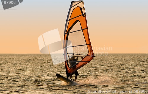 Image of Silhouette of a windsurfer on the sea