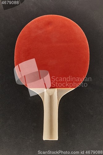 Image of Pingpong racket on dark surface