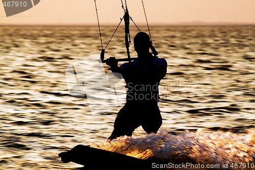 Image of Silhouette of a kitesurfer on a gulf