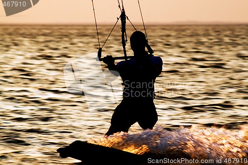 Image of Silhouette of a kitesurfer on a gulf