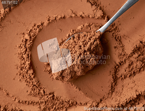 Image of spoon of cocoa powder