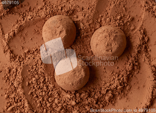 Image of chocolate truffles on cocoa powder background
