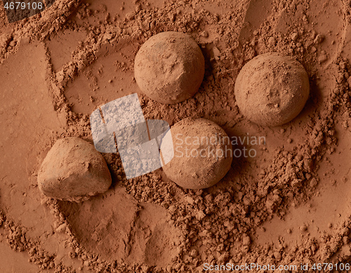 Image of chocolate truffles on cocoa powder background