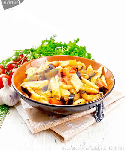 Image of Pasta penne with eggplant and tomatoes on napkin