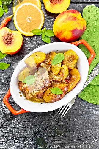 Image of Turkey with peaches in pan on board top