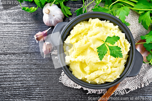 Image of Potatoes mashed in saucepan on board top