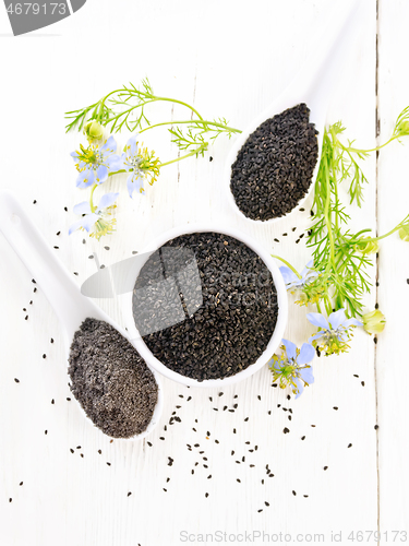 Image of Seeds of black cumin in bowl on light board top