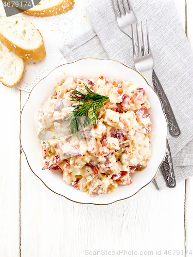 Image of Salad with chicken and vegetables in plate on light board top