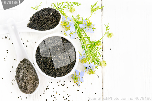 Image of Seeds of black cumin in bowl on board top