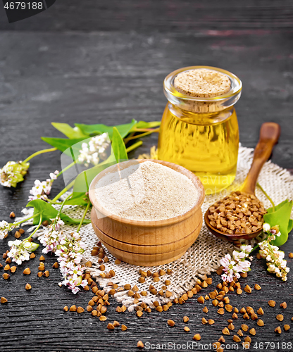 Image of Flour buckwheat brown in bowl with oil on wooden board