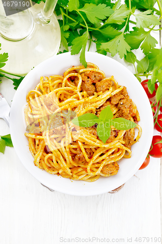 Image of Spaghetti with bolognese in plate on board top