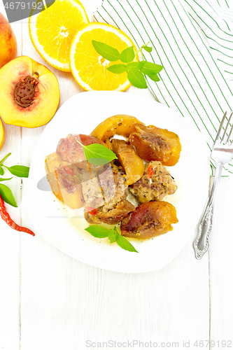 Image of Turkey with peaches in plate on light board top