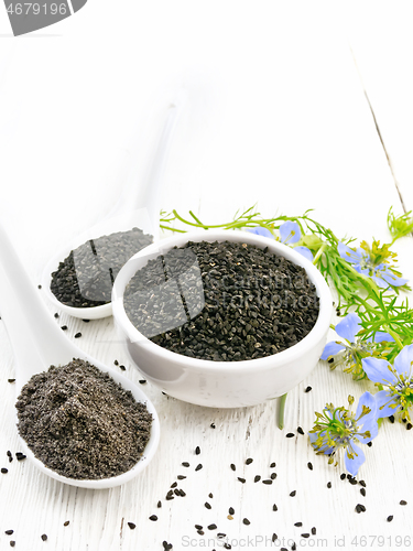 Image of Seeds of black cumin in bowl on white board