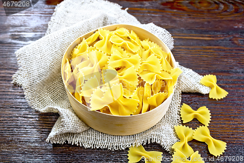 Image of Farfalle in bark box on dark board