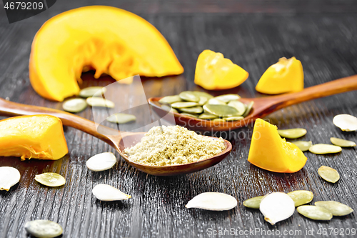 Image of Flour and seeds pumpkin in spoons on board