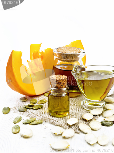 Image of Oil pumpkin in vial on wooden board