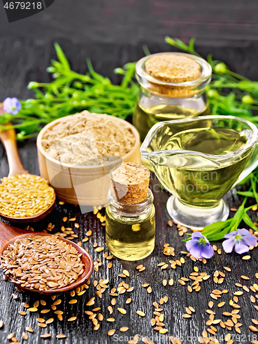 Image of Oil flaxseed with flour and seeds on wooden board