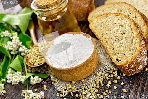 Image of Flour buckwheat green in bowl with bread on wooden board