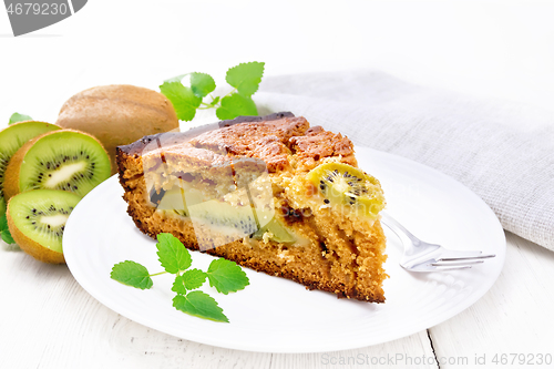 Image of Pie with kiwi in plate on wooden white board