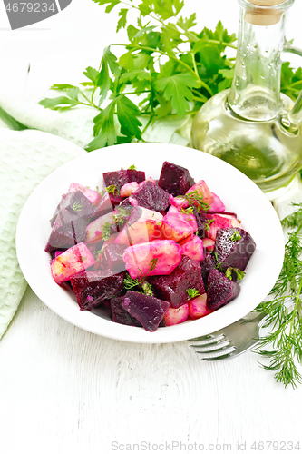 Image of Salad of beets and potatoes in plate on light board