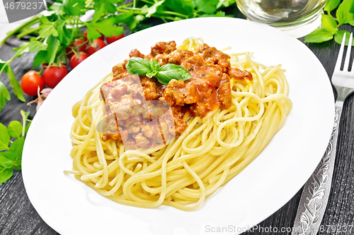 Image of Spaghetti with bolognese on dark board