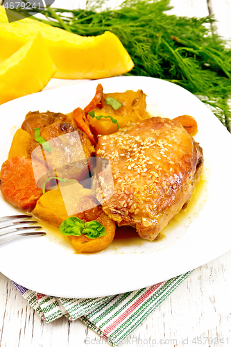 Image of Chicken roast with pumpkin and dried apricots on napkin