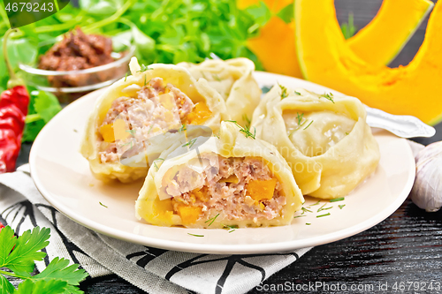 Image of Manty with meat and pumpkin in plate on dark board