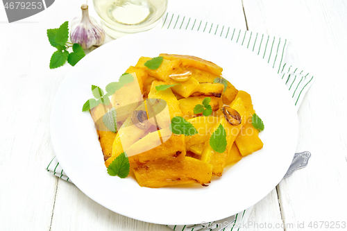 Image of Pumpkin with garlic in plate on light board