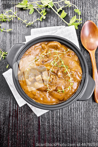 Image of Goulash of beef in pan on wooden board top