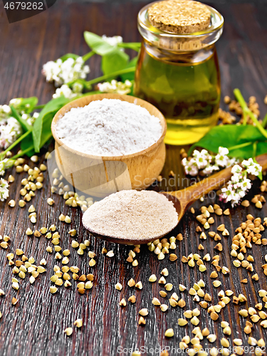 Image of Flour buckwheat brown in spoon with oil on wooden board