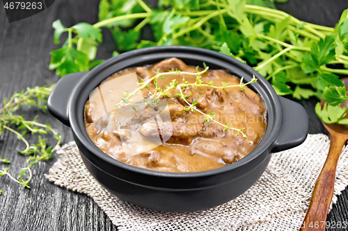 Image of Goulash of beef in pan on dark board