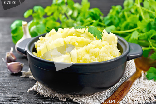Image of Potatoes mashed in saucepan on burlap